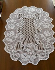 a white doily sitting on top of a wooden table