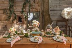 a wooden table topped with plates covered in flowers