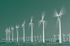 a row of wind turbines in the desert