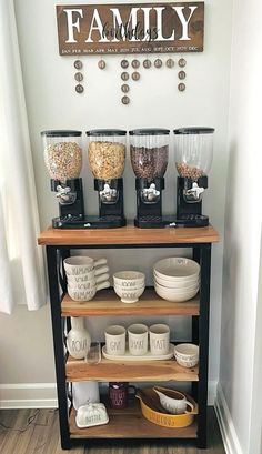 a shelf filled with cups and bowls next to a sign that says family on it