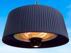 a black lamp hanging from the ceiling with a blue sky in the backgroud