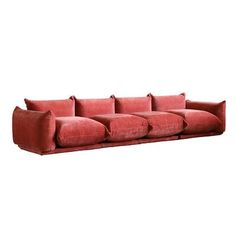 a red couch sitting on top of a white floor