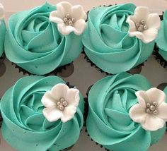 cupcakes decorated with blue frosting and white flowers