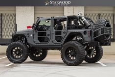 a black jeep parked in front of a building