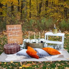 a table with pillows and candles on it in front of a sign that says together we have made place to be