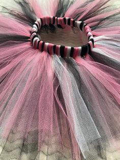 This listing is for a pink, black, and white tutu.  Colors and sizes can be customized to fit your needs. If you would like a shorter length, please specify when you order. If you need a longer skirt, please send me a custom order request before you purchase. A bow can be added to the tutu at no additional cost. I have plenty of ribbon colors, just let me know what color you would like in your order notes if the color is not listed on the dropdown menu! Size Chart Infant (0-18 months) - fits 14-18" waist - 6" length  Toddler (2T-4T) - fits 18-24" waist - 8" length Young Girls (5T-10) - fits 22-28" waist - 10"length Older Girls (12-16) - fits 26-34" waist - 12" length Adult XS-S-M - fits 30-40" Waist - 14" Length Adult L-XL-XXL - 38-48" Waist - 14" Length Please take careful measurements be Black And White Birthday, Handmade Tutu, Girls Costumes, White Tutu, Rose Noir, White Birthday, Baby Tutu, Birthday Tutu, Tutus For Girls