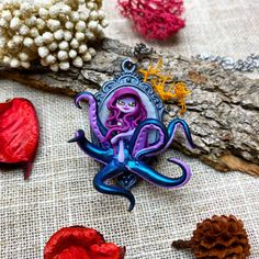 This pretty lady octopus with her blue tentacles and her light purple hair is exclusively made out of polymerclay (no paintings or pastel), and is about 5cm (2 inch) tall. On a 45cm long chain (mid-long necklace), stainless steel chirurgical chain. This jewelry is a perfect gift to add a touch of color and fantasy to your everyday life ! ---------- Shipping When your chibi will be travelling to your place she will be in a protective box with cotton inside a bubble mailers that will be tracked to ensure that she'll arrive safely.  ---------- You want your very own creation ? If you like my work but don't find the one that fits you, send me a message ! I'll do my best to help you define your creation and give you a price and the time nedded.And while I'll be creating your very own one I'll s Lady Octopus, Ursula Shell Necklace, Ursula's Necklace, Unique Purple Jewelry With Large Pendant, Purple Amulet Necklace, Light Purple Hair, Purple Lady, Octopus Pendant, Fantasy Doll