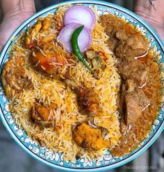 a plate with rice, meat and vegetables on it