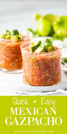 two small cups filled with mexican gazpacho sauce on top of a white plate