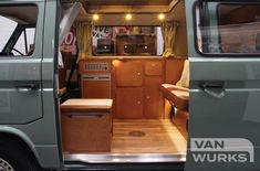 the interior of an old van with wood flooring and wooden trimmings on it