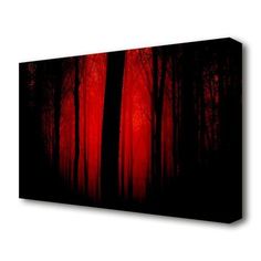 a red and black forest with trees in the background canvas art print on wall decor