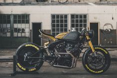 a yellow and black motorcycle parked in front of a building