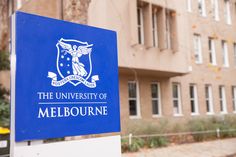 the university of melbourne sign in front of a building