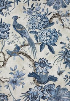 a blue and white floral wallpaper with birds on branches, flowers, and leaves