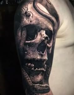 a man's arm with a skull and snake tattoo on it, while he is wearing