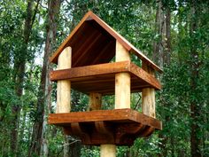 a wooden bird house in the woods