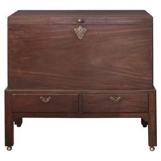 an old wooden chest with two drawers on one side and brass hardware at the top