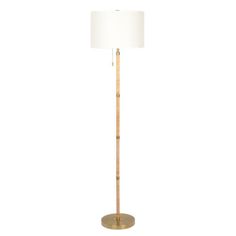 a tall wooden floor lamp with a white shade on the base and a gold metal base