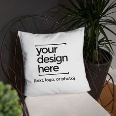 a white pillow sitting on top of a chair next to a potted plant