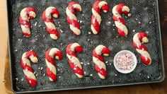 some candy canes are on a baking sheet