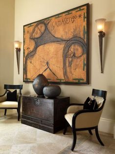 a living room filled with furniture and art on the wall