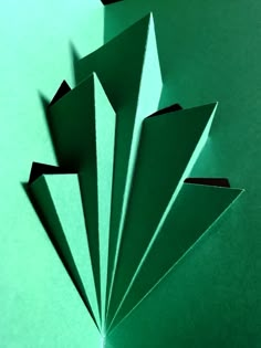 several pieces of green paper are folded together