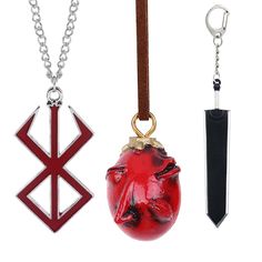 three different types of pendants hanging from chains on a white background, one with an arrow and the other with a demon's head