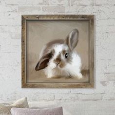 a painting of a rabbit in a frame on a brick wall