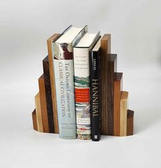 If you're still searching for the perfect gift for your loved ones, consider gifting them a set of handmade stepped wood bookends. These bookends come in different kinds of wood such as white oak, walnut, mahogany, maple, and cherry wood, and are perfect for keeping books organized without taking up too much space.  You can place them vertically or horizontally, whichever way you prefer, making them a versatile addition to any home. These decorative bookends also make for a charming and thoughtf Book Stopper, Book Ends Ideas, Diy Bookends Easy, Bookends Ideas, Homemade Bookends, Book Ends, Diy Bookends, Tung Oil Finish, Wood Bookends