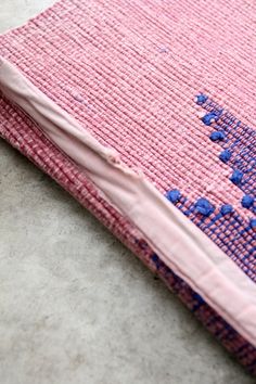 a piece of cloth with blue dots on it sitting on the floor next to a pair of scissors