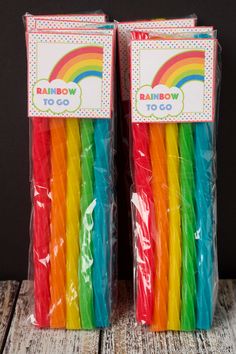 two bags of rainbow toothbrushes sitting next to each other