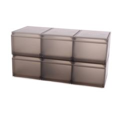 a set of four storage boxes sitting on top of each other in front of a white background