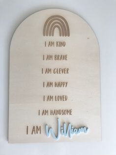 a wooden plaque with the words i am william on it and a rainbow in the background