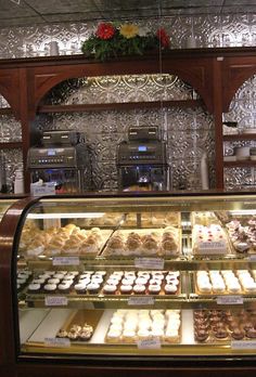 a display case filled with lots of different types of doughnuts and pastries