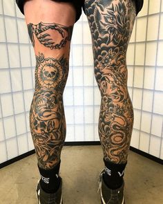 the legs and ankles of a man with tattoos on them