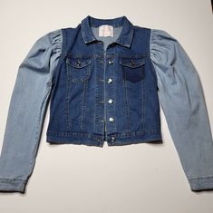 Women's Two-Tone Bubble Shoulder Denim Jean Jacket Coat Color: Blue Denim Size M 78% Cotton, 21% Polyester, 1% Spandex New Without Tags Excellent Pre-Owned Condition Stretch Medium Wash Winter Outerwear, Stretch Medium Wash Outerwear For Winter, Fall Cotton Denim Top, Medium Wash Stretch Denim Jacket With Long Sleeves, Trendy Stretch Blue Denim Vest, Trendy Blue Stretch Denim Vest, Stretch Medium Wash Long Sleeve Outerwear, Blue Stretch Denim Jacket With Long Sleeves, Trendy Stretch Medium Wash Outerwear