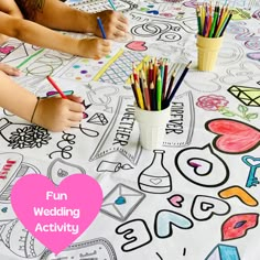 a child is drawing on a table covered with coloring paper