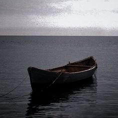 a small boat floating on top of a large body of water