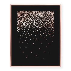 a black and gold framed artwork with small dots on it