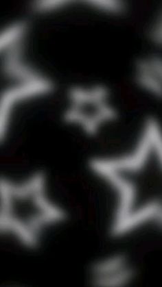 blurry image of white stars on black background