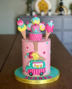 a pink cake decorated with ice cream and sprinkles on a wooden table