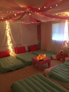 a bed room with twin beds and lights on the ceiling