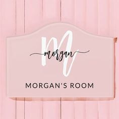 a sign that says morgan's room hanging on the side of a pink wall