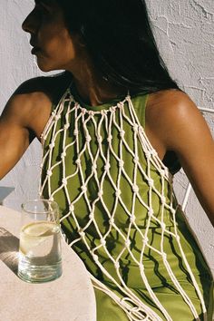 a woman sitting at a table with a glass of water