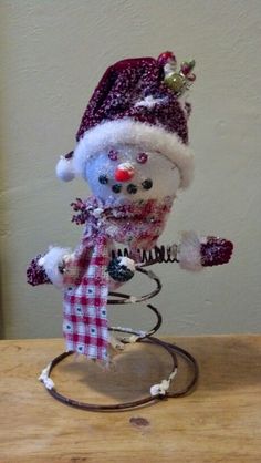 a snowman figurine on a wooden table