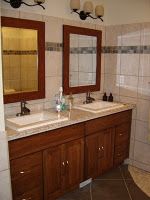 a bathroom with two sinks and mirrors in it