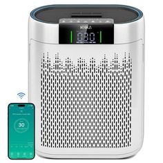 an alarm clock radio next to a cell phone with the appliance on it