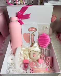 a pink gift box filled with personal care items and accessories for the girl in your life