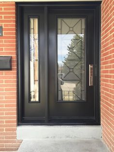 a black double door on a brick building