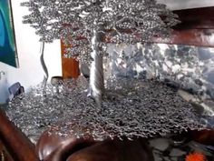 a silver tree sitting on top of a wooden table